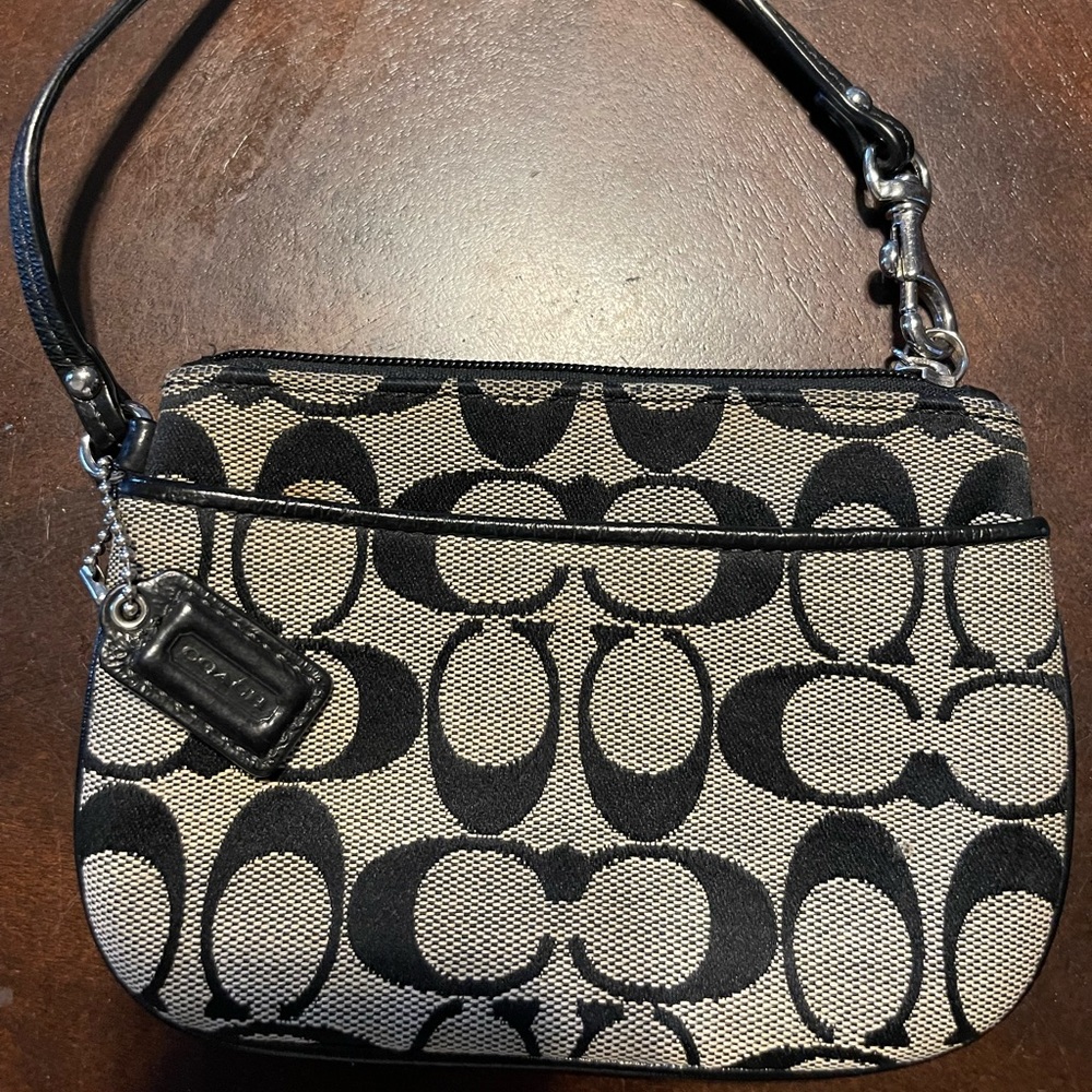 COACH wristlet in their signature print in black & brown.